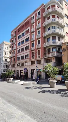 a large red brick building on the side of a street at Nicasa, accogliente appartamento nel cuore di Palermo in Palermo