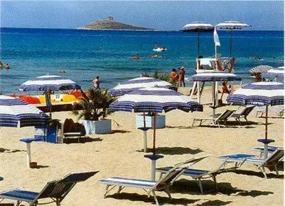 a beach with blue and white chairs and umbrellas at Paradiso del mare, Appartamento accogliente vicino a mare, metro, aeroporto e Palermo in Capaci