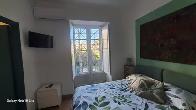 a bedroom with a bed and a window at Le Calette Palermo in Palermo