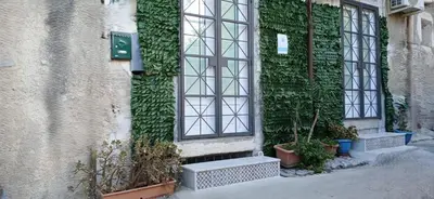 a building with green ivy on the side of it at Le Calette Palermo in Palermo