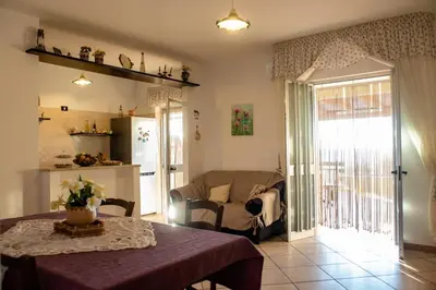 a living room with a table and a couch at Liberia vacanze - A POCHI PASSI dal mare in Alcamo