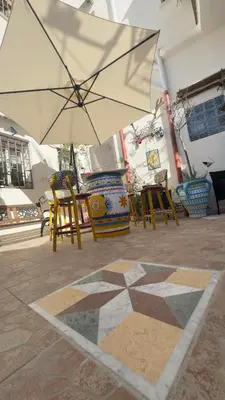 a white umbrella sitting on top of a patio at Cortile Siciliano in Palermo