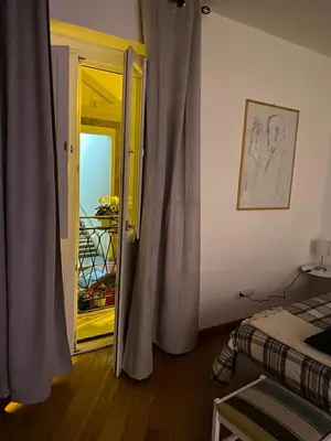 a bedroom with a door open to a balcony at Cate Home historic center in Palermo