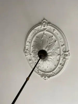 a clock hanging from the ceiling of a room at La Dimora della Maestra in Vita