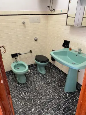 a bathroom with a toilet and a sink at La Dimora della Maestra in Vita