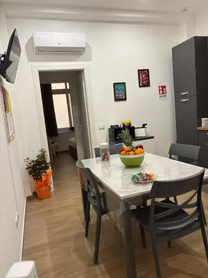 a kitchen and dining room with a table and chairs at Residenza Stabile 64 in Palermo
