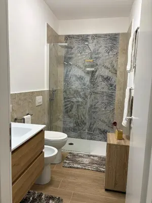 a bathroom with a toilet sink and a shower at Residenza Stabile 64 in Palermo