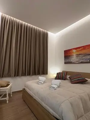 a bedroom with a bed and a large window at Residenza Stabile 64 in Palermo