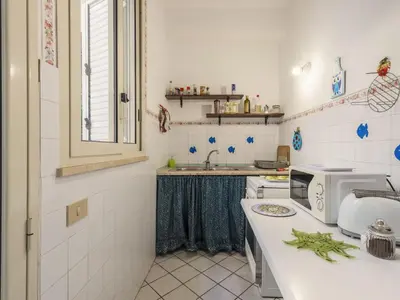 a kitchen with a sink and a microwave on a counter at Apartment Cicladi Amorgos by Interhome in Santa Flavia