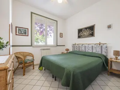 a bedroom with a green bed and a window at Apartment Cicladi Amorgos by Interhome in Santa Flavia