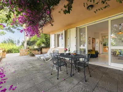 a patio with a table and chairs on a house at Apartment Cicladi Amorgos by Interhome in Santa Flavia