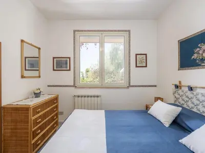 a bedroom with a bed and a dresser and a window at Apartment Cicladi Anafi by Interhome in Santa Flavia