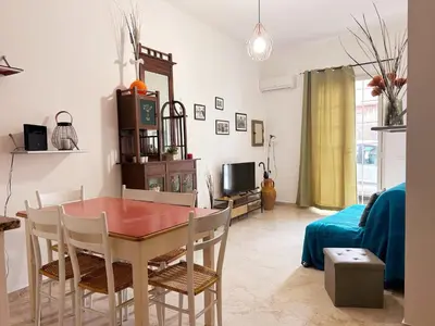 a living room with a dining room table and chairs at Dai Nonni in Terrasini