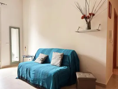 a blue couch with two pillows on it in a room at Dai Nonni in Terrasini