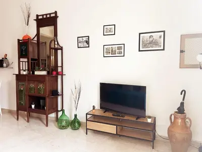a living room with a flat screen tv and vases at Dai Nonni in Terrasini