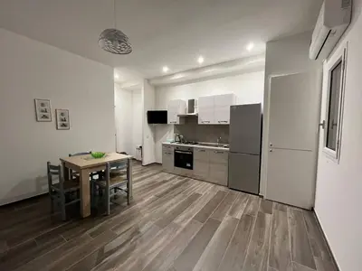 a kitchen and dining room with a table in a room at Casa Francesca in Capaci