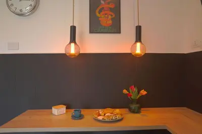 a table with a plate of food and lights at Courthouse Apartments Palermo in Palermo