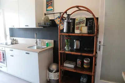 a kitchen with a sink and a shelf at Courthouse Apartments Palermo in Palermo