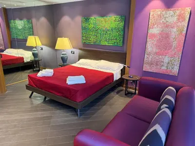 a bedroom with a bed and a couch at Amari 124 in Palermo