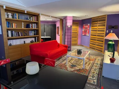 a living room with a red couch and a table at Amari 124 in Palermo