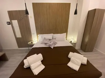 a bedroom with a large bed with two pillows at Palazzo Castelli alla Zisa in Palermo