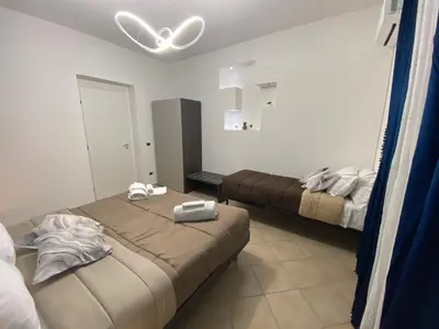 a bedroom with two beds in a room at Palazzo Castelli alla Zisa in Palermo