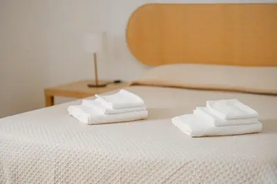 two towels sitting on top of a bed at MonSea in Palermo