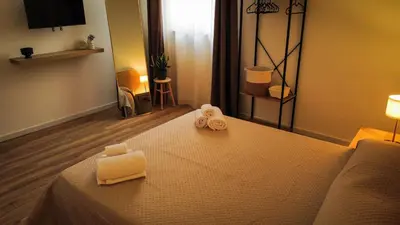 a hotel room with a bed with two towels on it at MonSea in Palermo