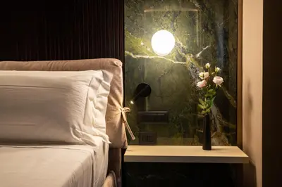 a bedroom with a bed and a vase with flowers on a table at Le Dimore - Ponte 7 in Palermo