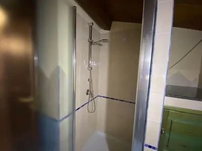 a shower in a bathroom with a glass door at Villa Sunset in Campofelice di Roccella