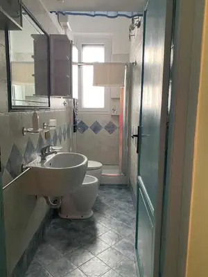 a bathroom with a sink and a toilet at irenes holiday house in Palermo