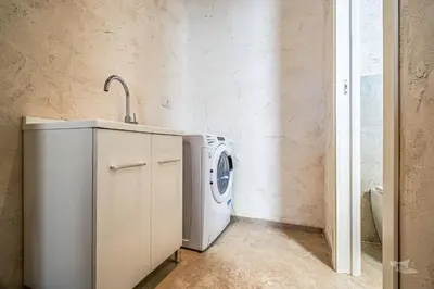 a laundry room with a washing machine and a sink at Villa Castello in Balestrate