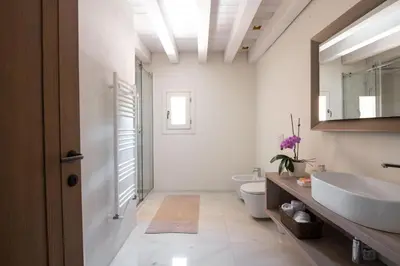a bathroom with a sink and a toilet and a mirror at Palazzo De Gregorio - Apartments in Palermo