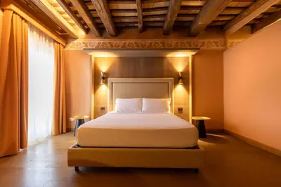 a bedroom with a bed and a large window at Palazzo De Gregorio - Apartments in Palermo