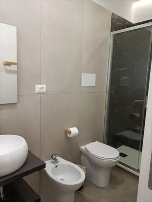 a bathroom with a toilet and a sink and a shower at La Ciconella 2 in Palermo