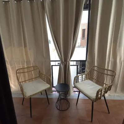 two chairs and a table in front of a window at La Ciconella 2 in Palermo