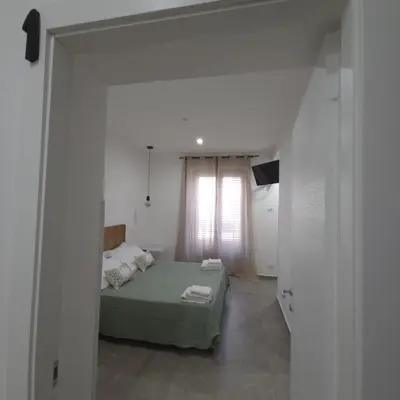 a bedroom with a green bed and a window at La Ciconella 2 in Palermo