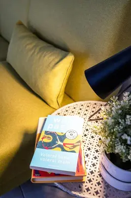 a book sitting on a table next to a couch at Capo Sweet Home in Palermo