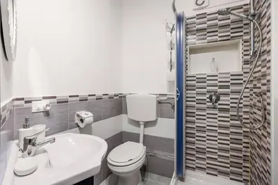 a bathroom with a toilet and a sink and a shower at Capo Sweet Home in Palermo