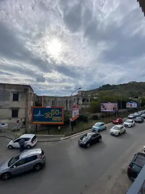 a group of cars parked on a city street at DADE Houses in Bagheria