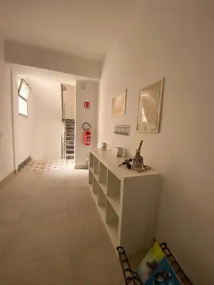 a room with a white counter and a hallway at DADE Houses in Bagheria
