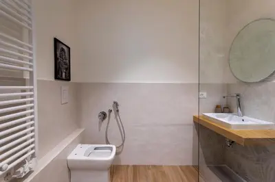 a bathroom with a shower and a toilet and a sink at Marina Rooms - Guesthouse in Palermo