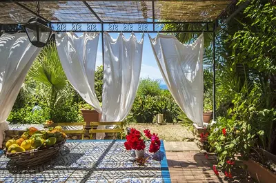 a patio with a table with a basket of fruit at Casa Panoramica in Terrasini