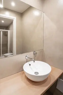 a bathroom with a white sink on a wooden counter at Casa Panoramica in Terrasini