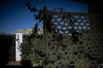 a white fence in front of a house at Residence Salinelle Beach Villa Panarea in Lascari