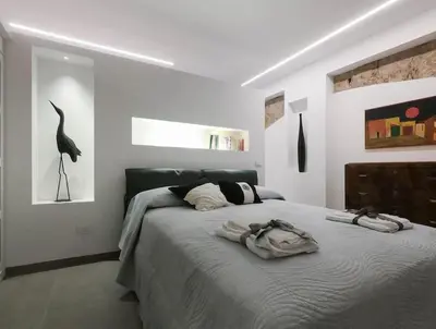 a bedroom with a bed with a bird on the wall at Genius Loci in Palermo