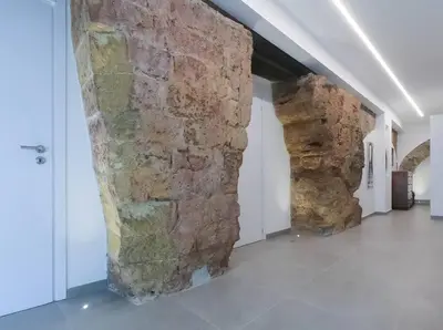 a hallway with two stone walls in a building at Genius Loci in Palermo