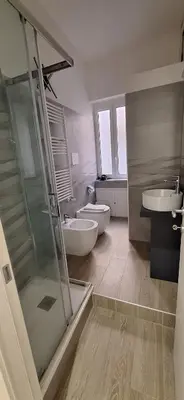 a bathroom with two toilets and a sink and a shower at Casa di Giulia in Palermo
