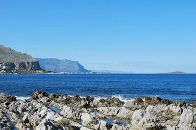 a group of rocks on the shore of a body of water at Casa Punta Barcarello, Sferracavallo fronte mare e tramonti da sogno, a due passi dalla splendida spiaggia di Mondello in Palermo