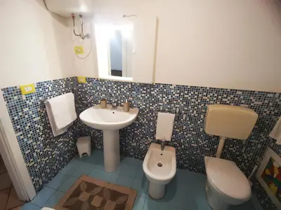 a bathroom with a sink and a toilet at kappa's house a granni in Palermo